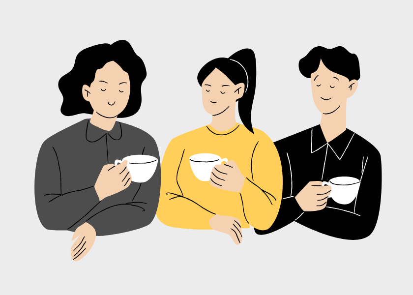 three people with cups of hot drinks